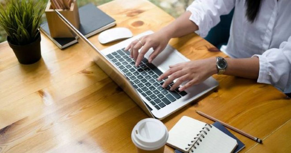 Bookkeeper working at a laptop in a home office